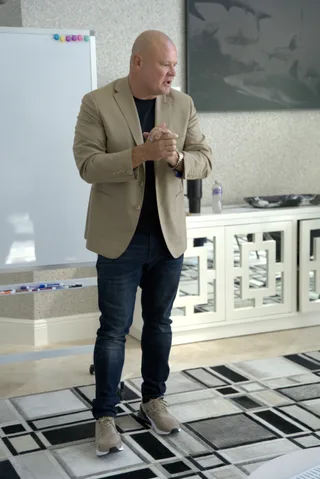 Shawn is teaching in an office with a whiteboard.